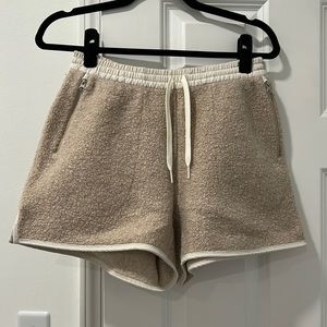Tan/beige Outdoor Voices RecTek shorts. Drawstring, zipper pockets.